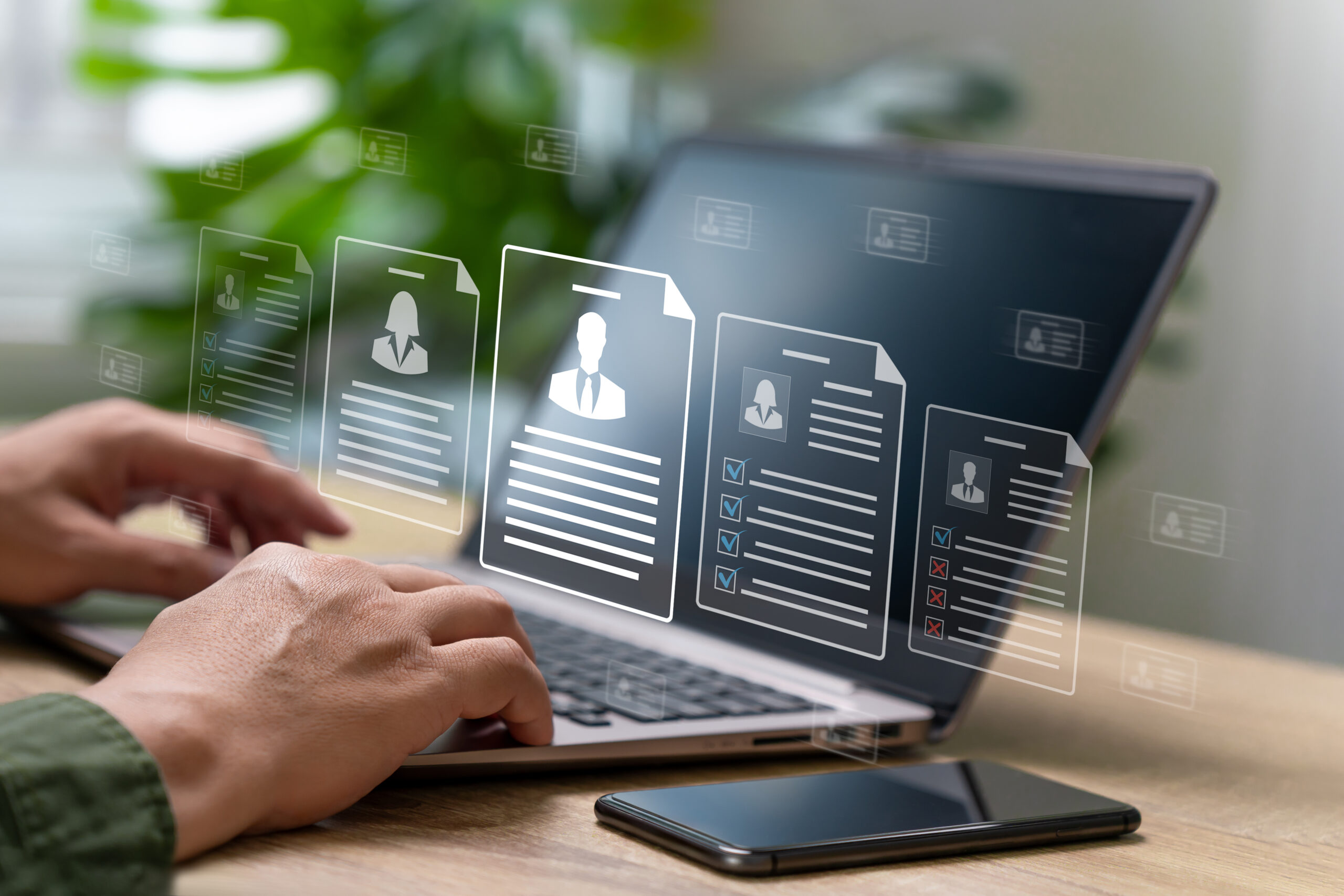 AI HR Agent streamlining recruitment and onboarding. HR manager reviewing candidate profiles on a laptop.